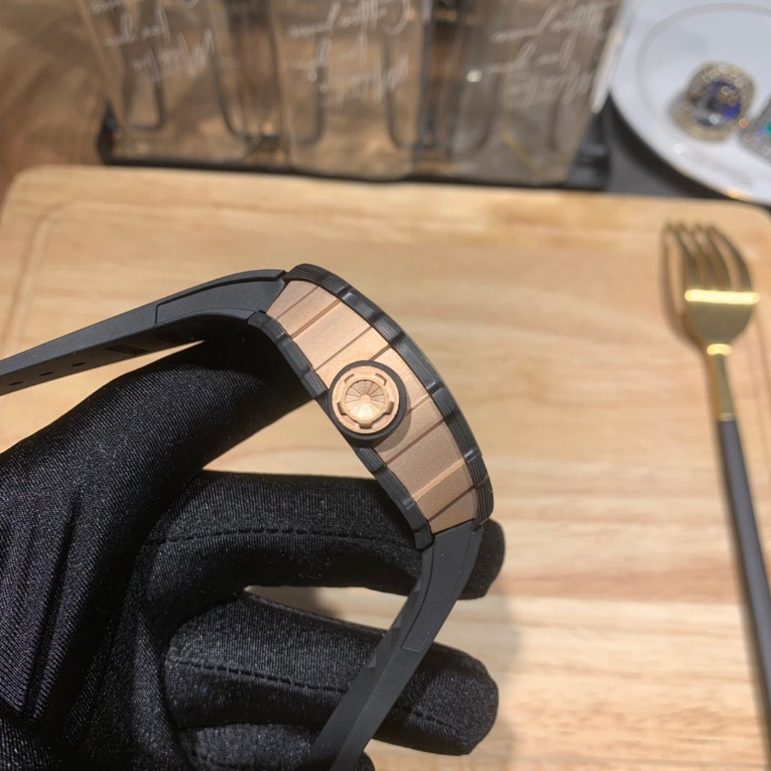 Black watch strap and octagonal case shown from the side with rose-gold tone accent