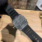 Black watch back with engraved pattern and screw details on a rubber strap