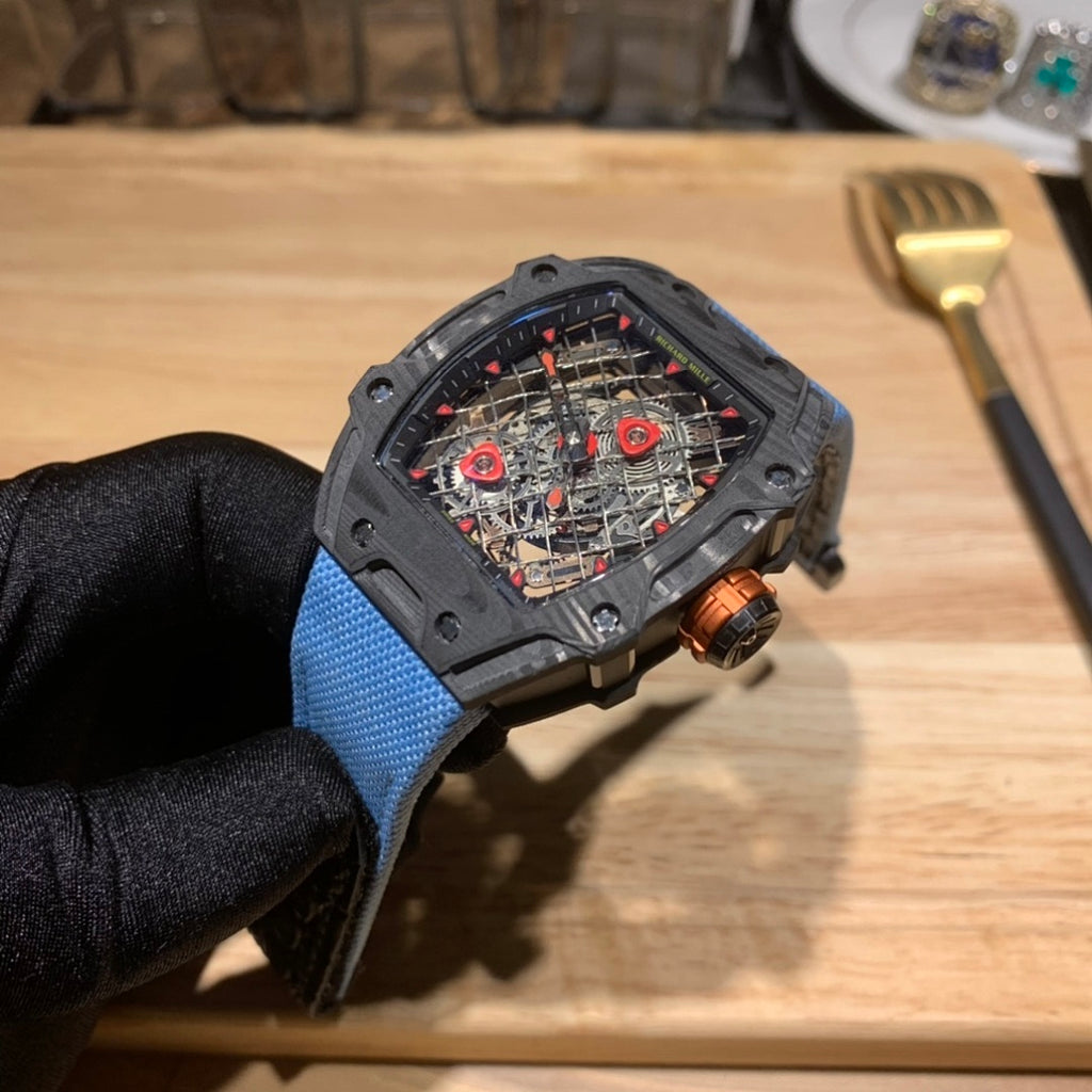Richard Mille watch with blue fabric strap and skeleton dial with red accents, side angle
