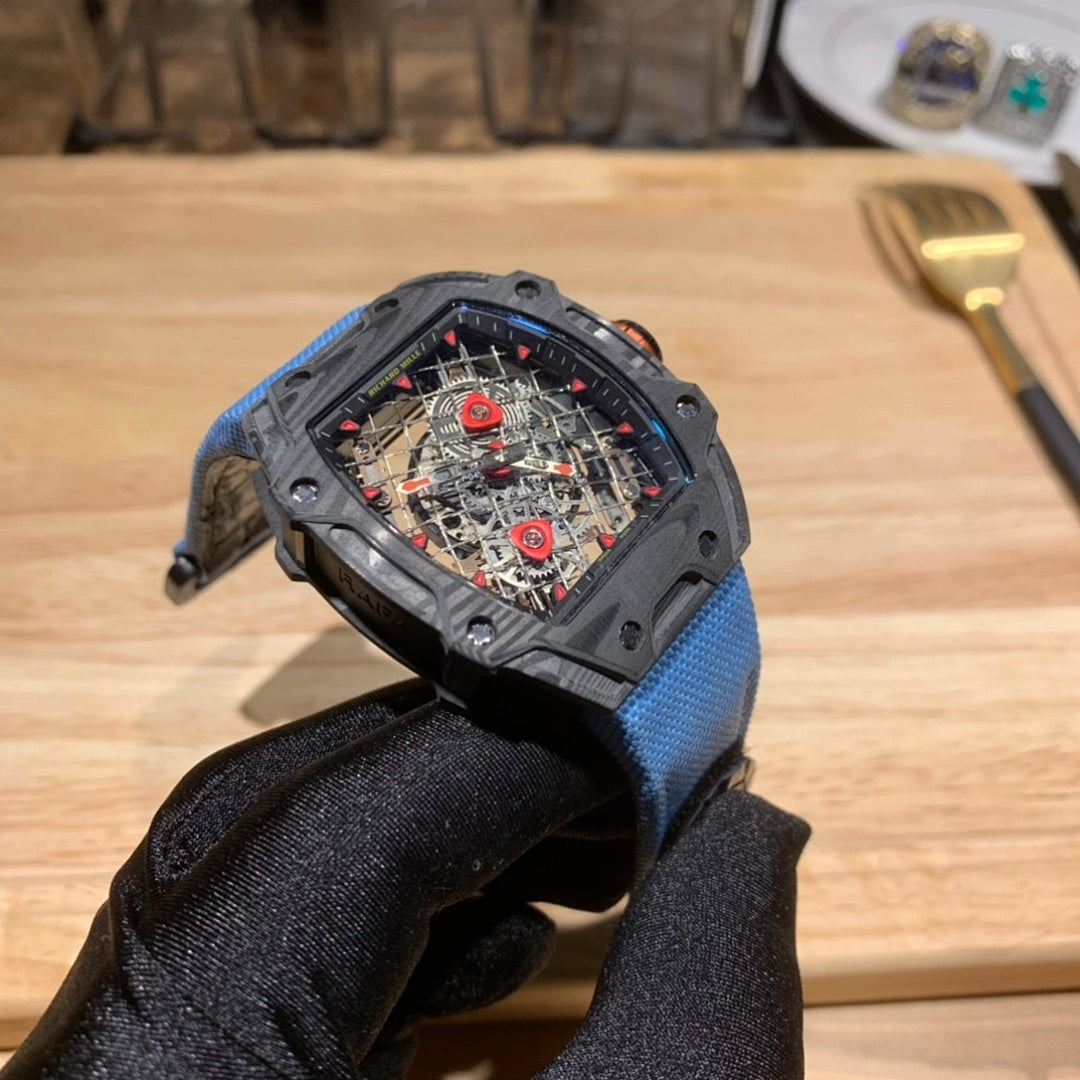 Richard Mille watch with blue fabric strap and dark case, skeleton dial facing left