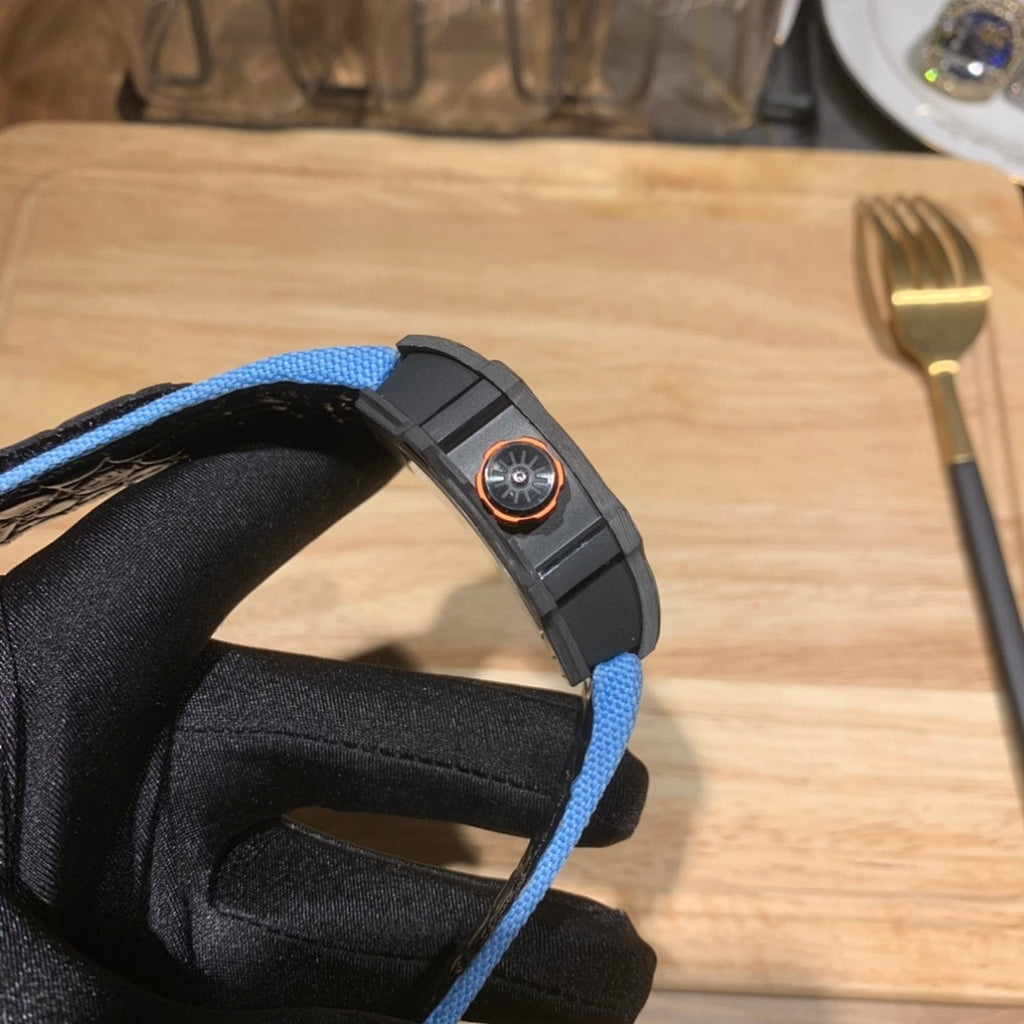 Richard Mille watch with blue fabric strap and dark bezel; crown detail