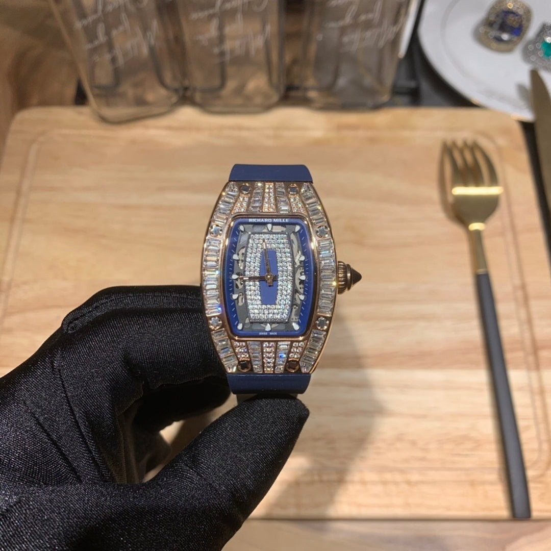 Richard Mille wristwatch on glove, blue dial and blue rubber strap, diamond bezel