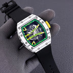Sport watch with black rubber strap and green skeleton dial, silver multi-panel case