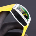 Sport watch side view with yellow rubber strap and black clasp, green dial window
