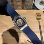 Richard Mille watch back view, blue strap with engraved branding and silver caseback