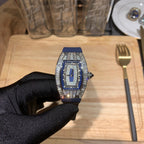 Richard Mille watch with blue strap and silver jeweled bezel, centered on gloved hand
