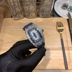 Richard Mille watch with blue strap and silver jeweled case, angled on gloved hand