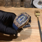 Men’s wristwatch with blue dial and diamond bezel, gold-toned side and blue rubber strap