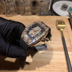 Side view of diamond-set luxury watch with black rubber strap