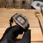 Luxury wristwatch with diamond-studded bezel and black dial on black strap