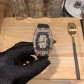 Diamond-set luxury watch with black dial and black rubber strap