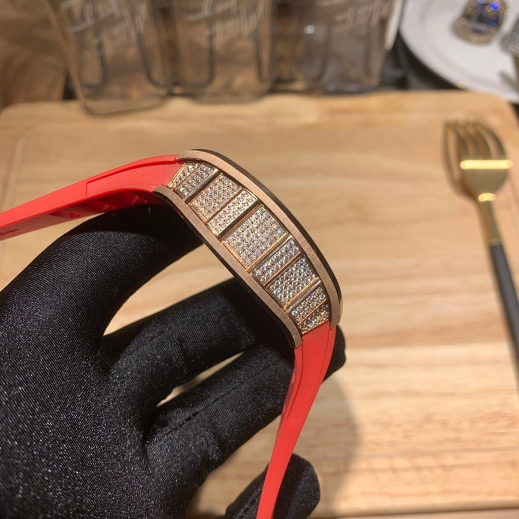 Red silicone watch strap and diamond-studded bezel close-up