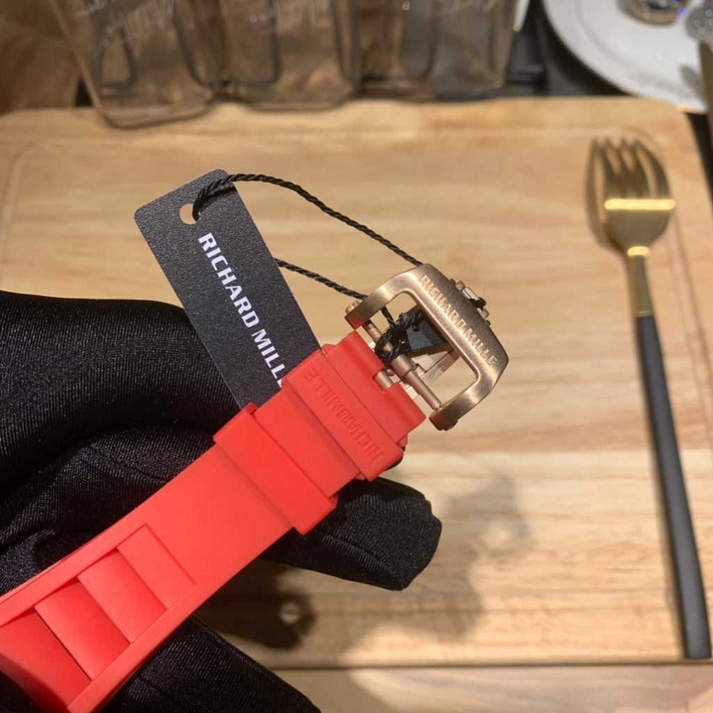 Richard Mille wristwatch on red silicone strap, underside and clasp visible
