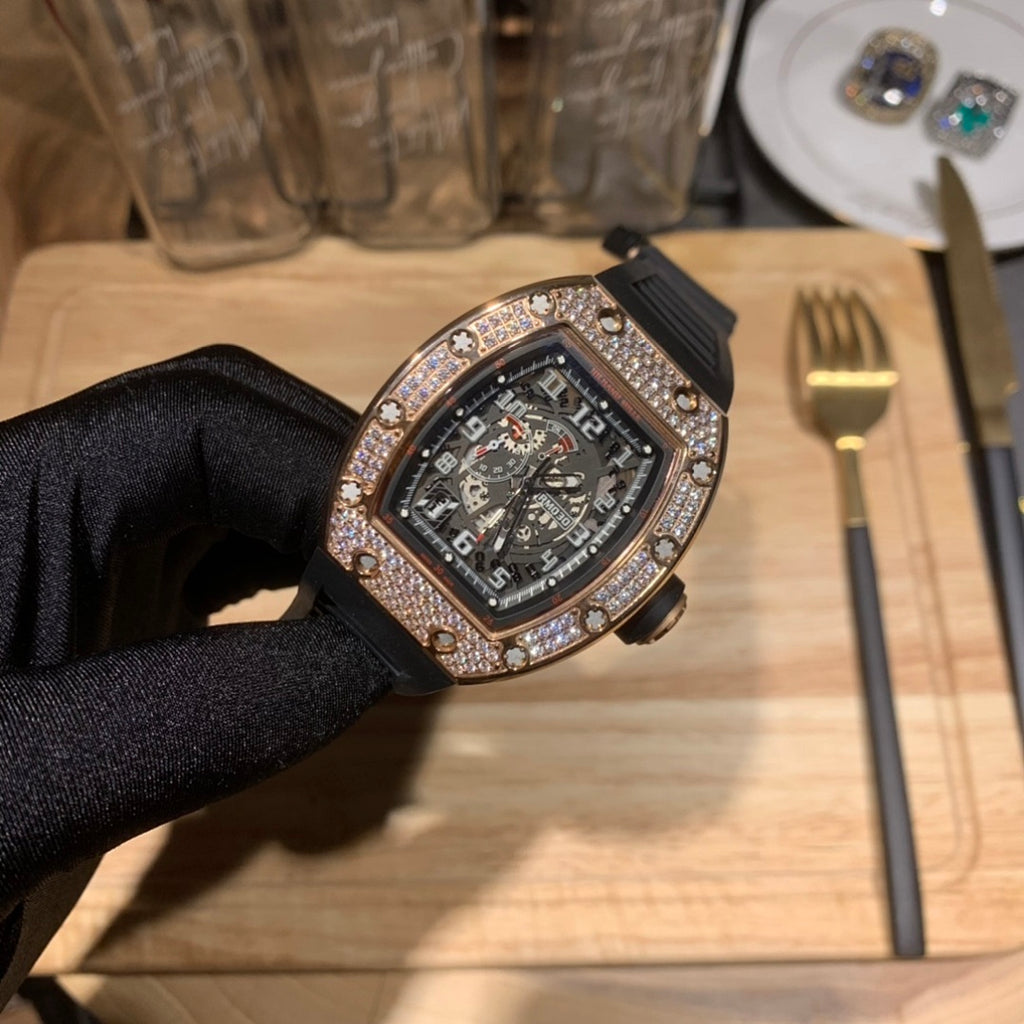 Richard Mille watch at an angle, jeweled bezel and dark skeleton-style dial on black strap