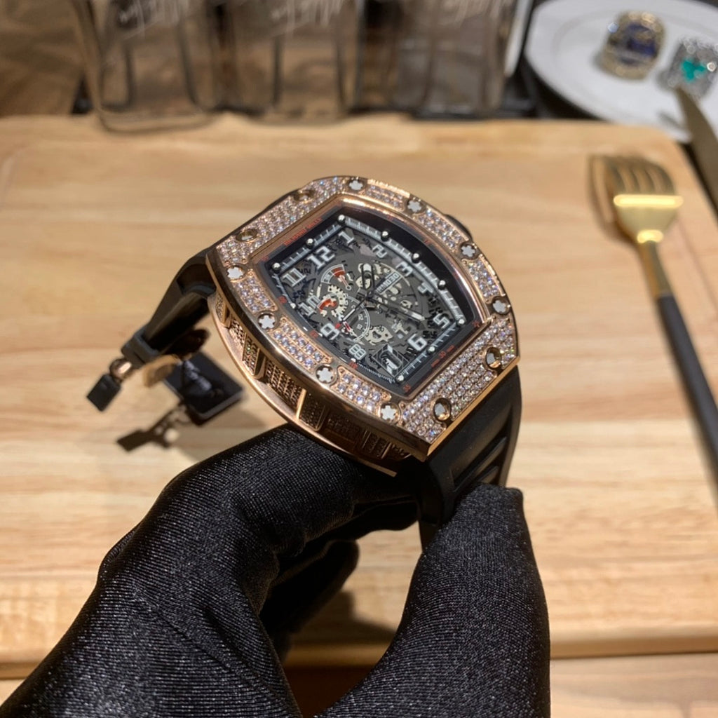 Richard Mille watch front view with jeweled bezel, dark dial, and black rubber strap