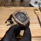 Richard Mille watch front view with jeweled bezel, dark dial, and black rubber strap