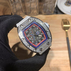 Luxury watch with white rubber strap and jeweled bezel, red-blue dial close-up