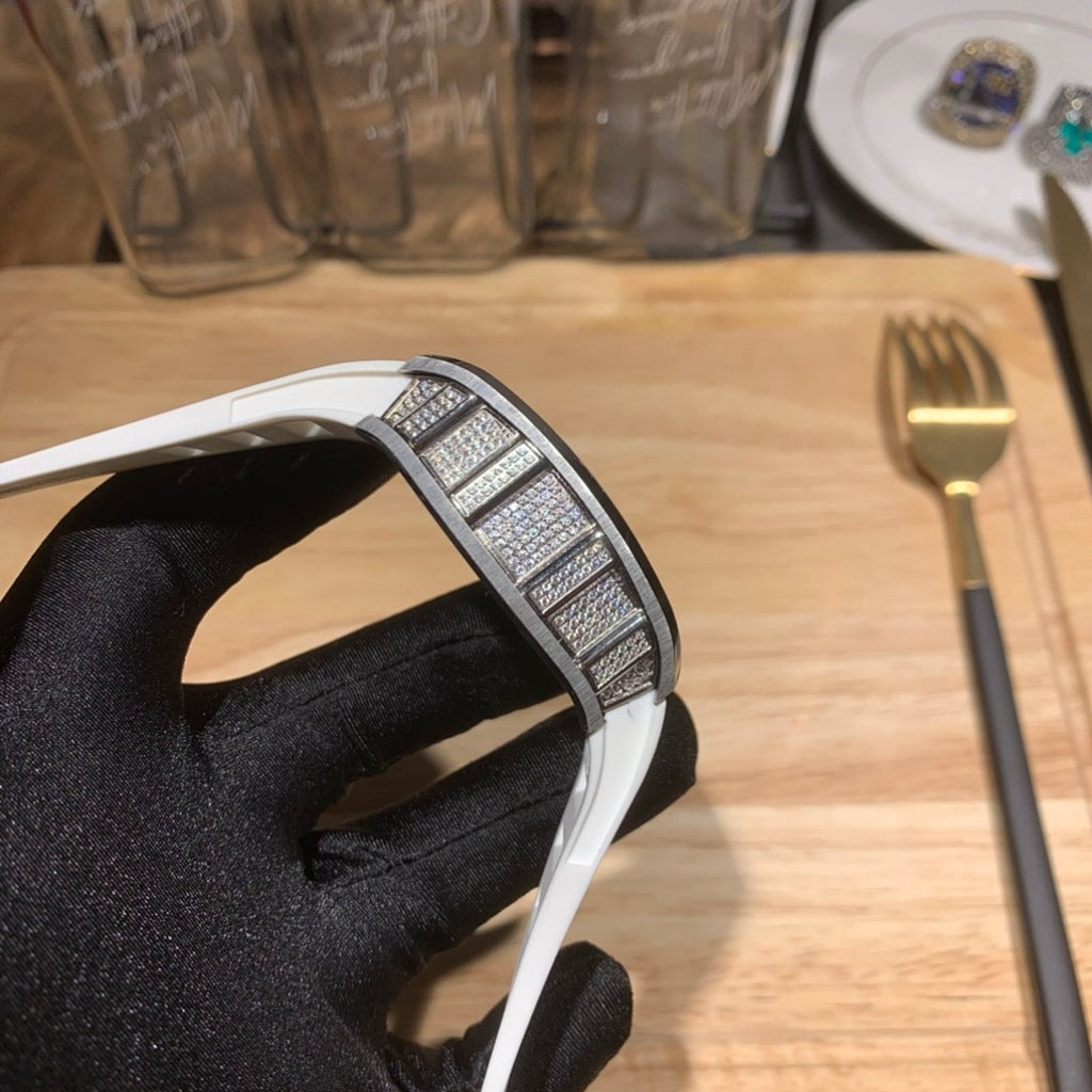 Luxury watch with white strap, jeweled bezel detail, curved case side view
