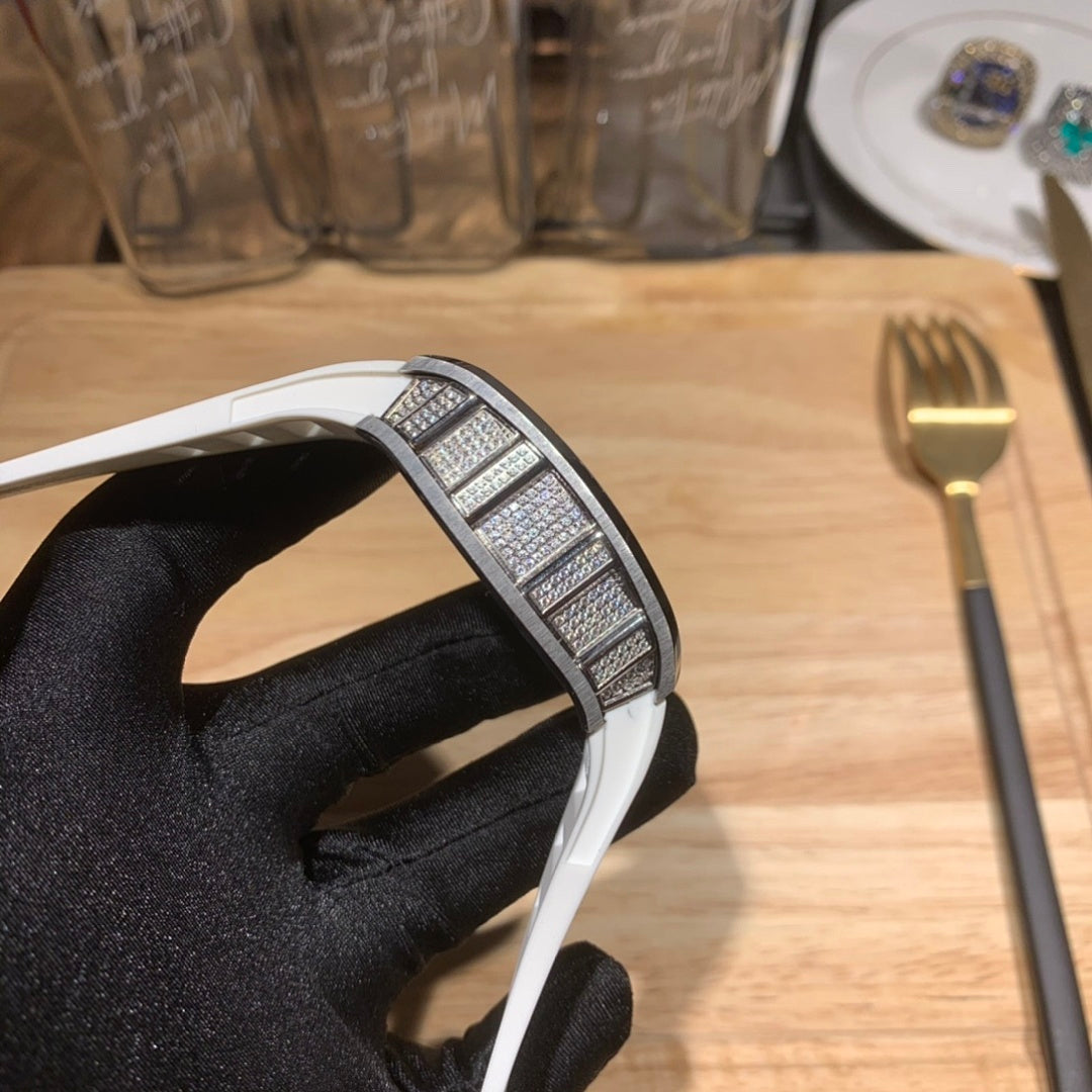 Luxury watch with white strap, jeweled bezel detail, curved case side view