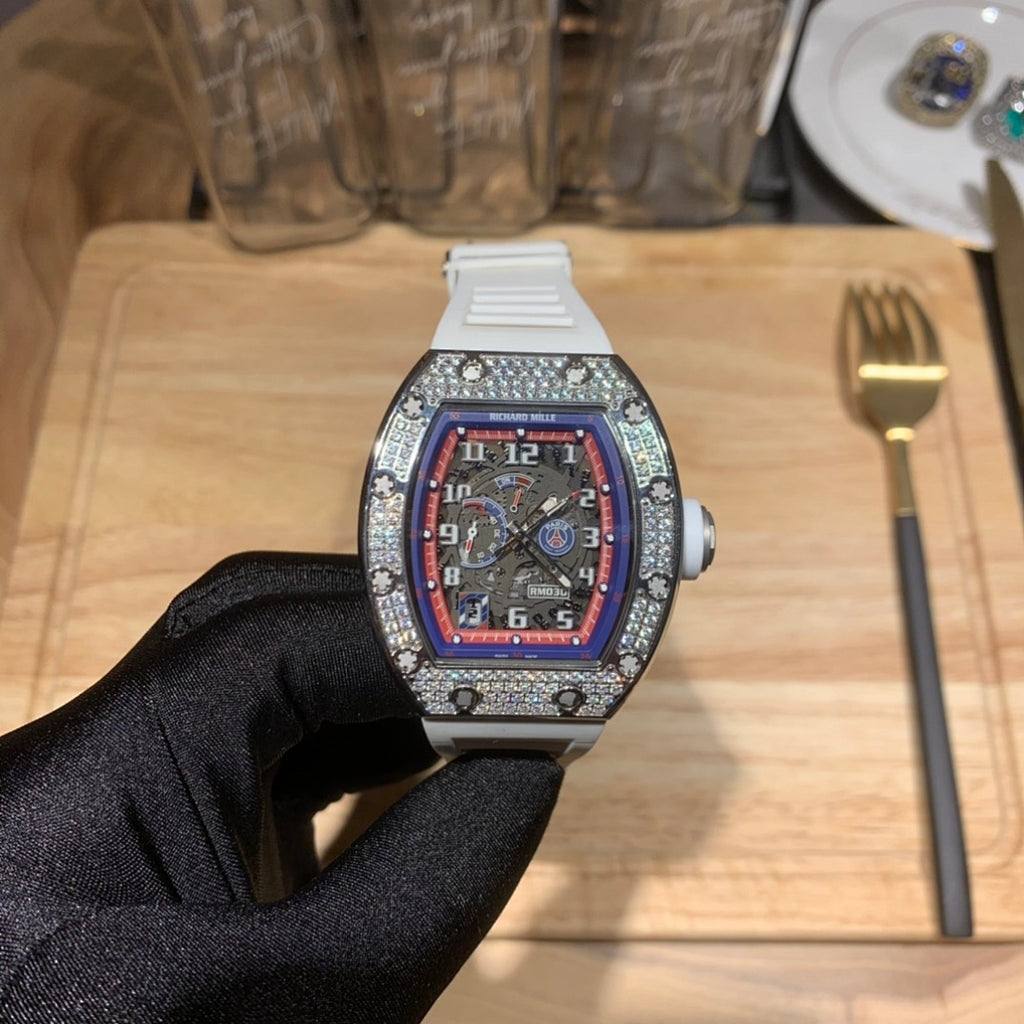 Luxury watch with white strap, jeweled bezel, and red-blue dial, front view
