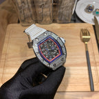Luxury watch with white rubber strap and jeweled case, red-blue dial in hand