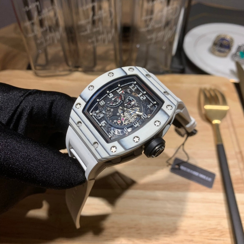 Richard Mille wristwatch three-quarter view, silver case with black dial.
