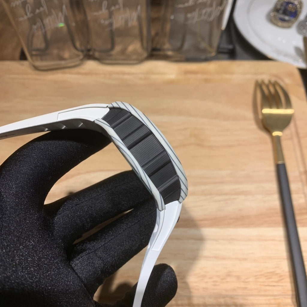 Richard Mille wristwatch strap and case side view with white and dark band.