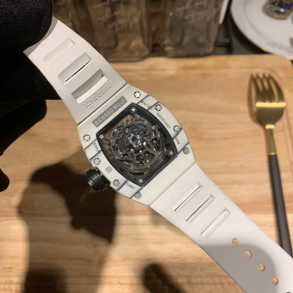 Richard Mille wristwatch underside view with white strap and dark dial window.