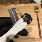Richard Mille rubber strap end with clasp and black wristband, tag visible.