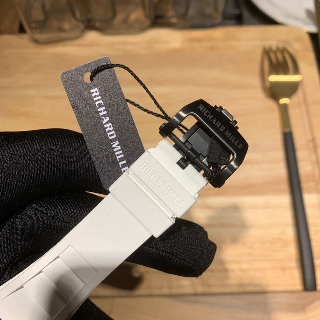Richard Mille rubber strap end with clasp and black wristband, tag visible.