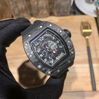 Richard Mille watch close-up with black bezel and skeleton dial detail under glass