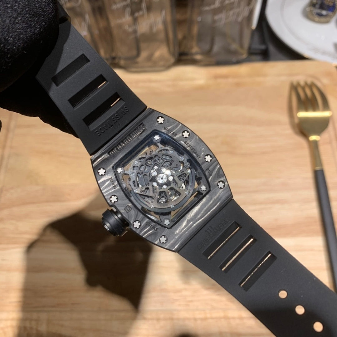Richard Mille watch side view with black strap, visible screw crown, and underside details