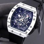 Richard Mille watch with white-toned case, blue skeleton dial, and black rubber strap.