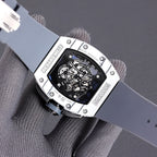 Richard Mille watch caseback with blue skeleton dial and stainless-toned screws on strap.