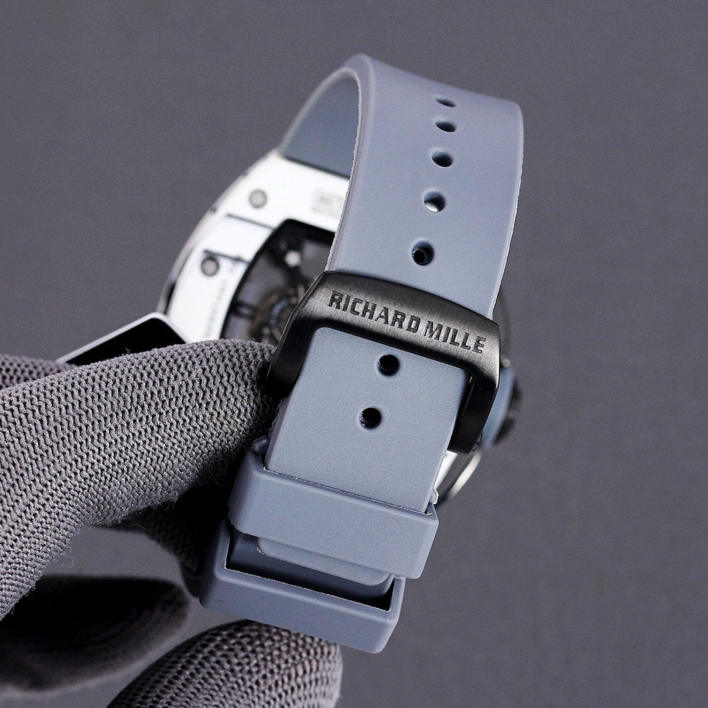 Richard Mille rubber strap buckle in light blue with black clasp and strap holes.