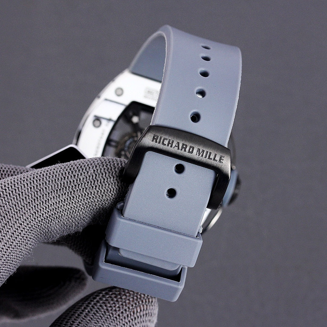 Richard Mille rubber strap buckle in light blue with black clasp and strap holes.