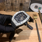 Richard Mille watch front view, black dial, silver case, and black rubber strap
