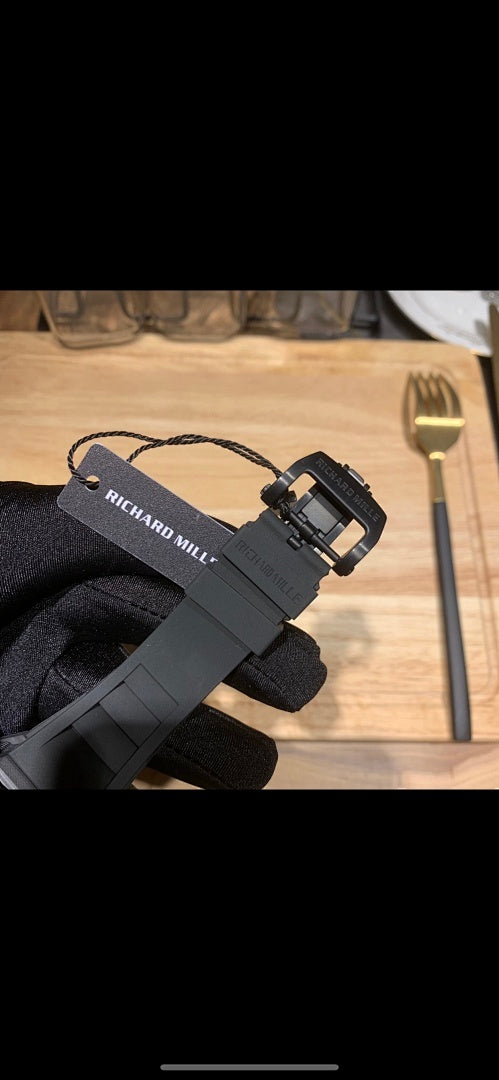 Richard Mille watch on glove with black rubber strap and hanging tag