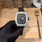 Richard Mille watch front view, black dial and silver case on black glove