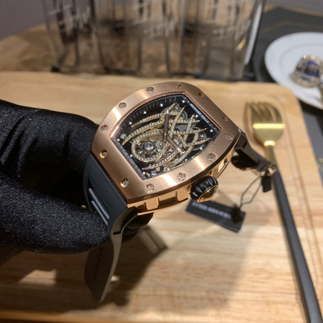 Richard Mille watch in hand with black strap, rose gold-toned case, visible side buttons