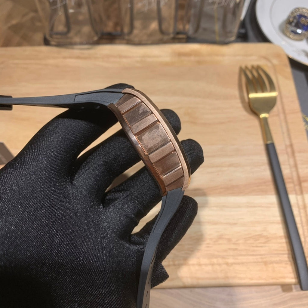 Richard Mille watch detail on bezel edge with black rubber strap and rose gold-toned finish