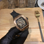 Richard Mille watch angled view with black rubber strap and rose gold-toned case