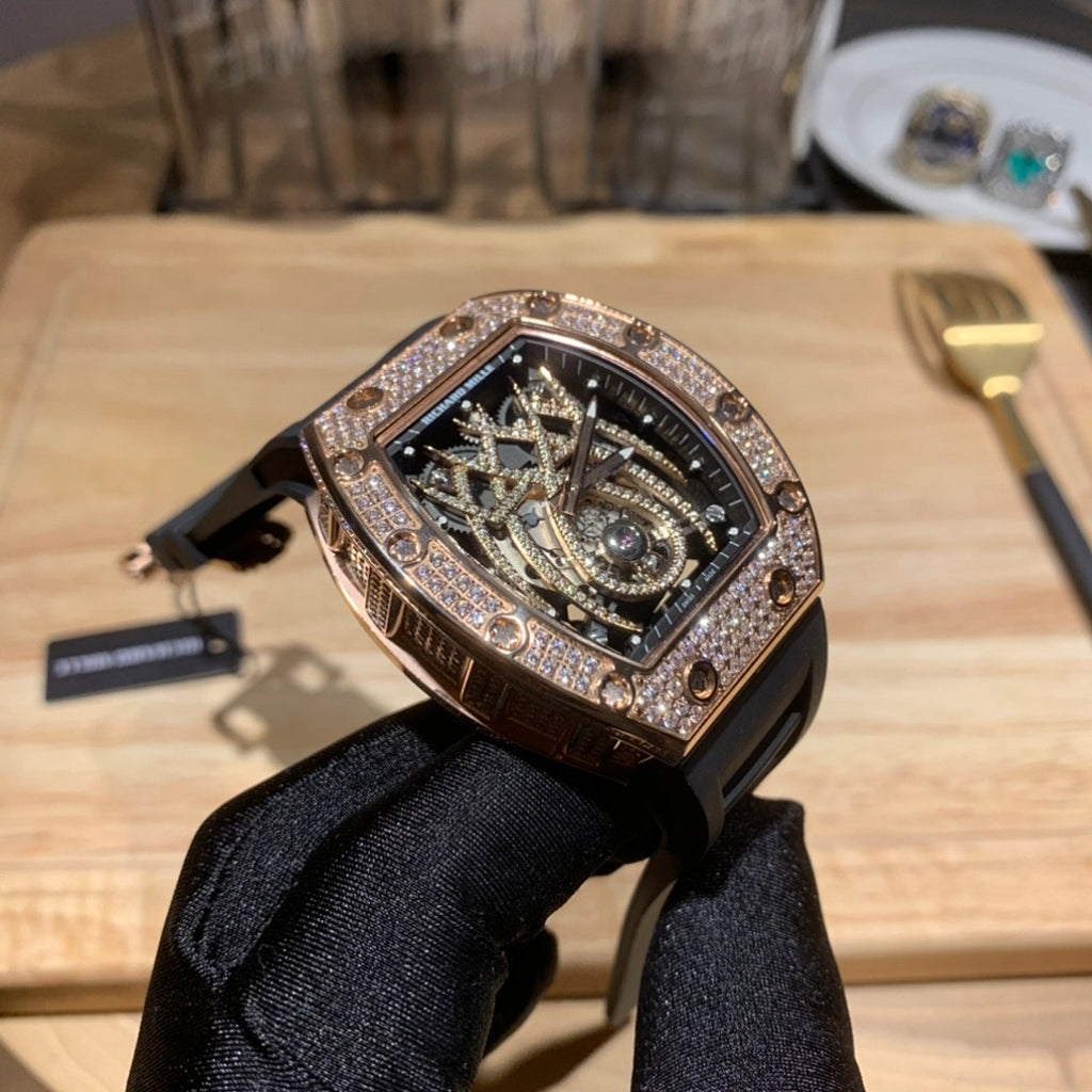 Richard Mille rose gold wristwatch with diamond bezel and black rubber band