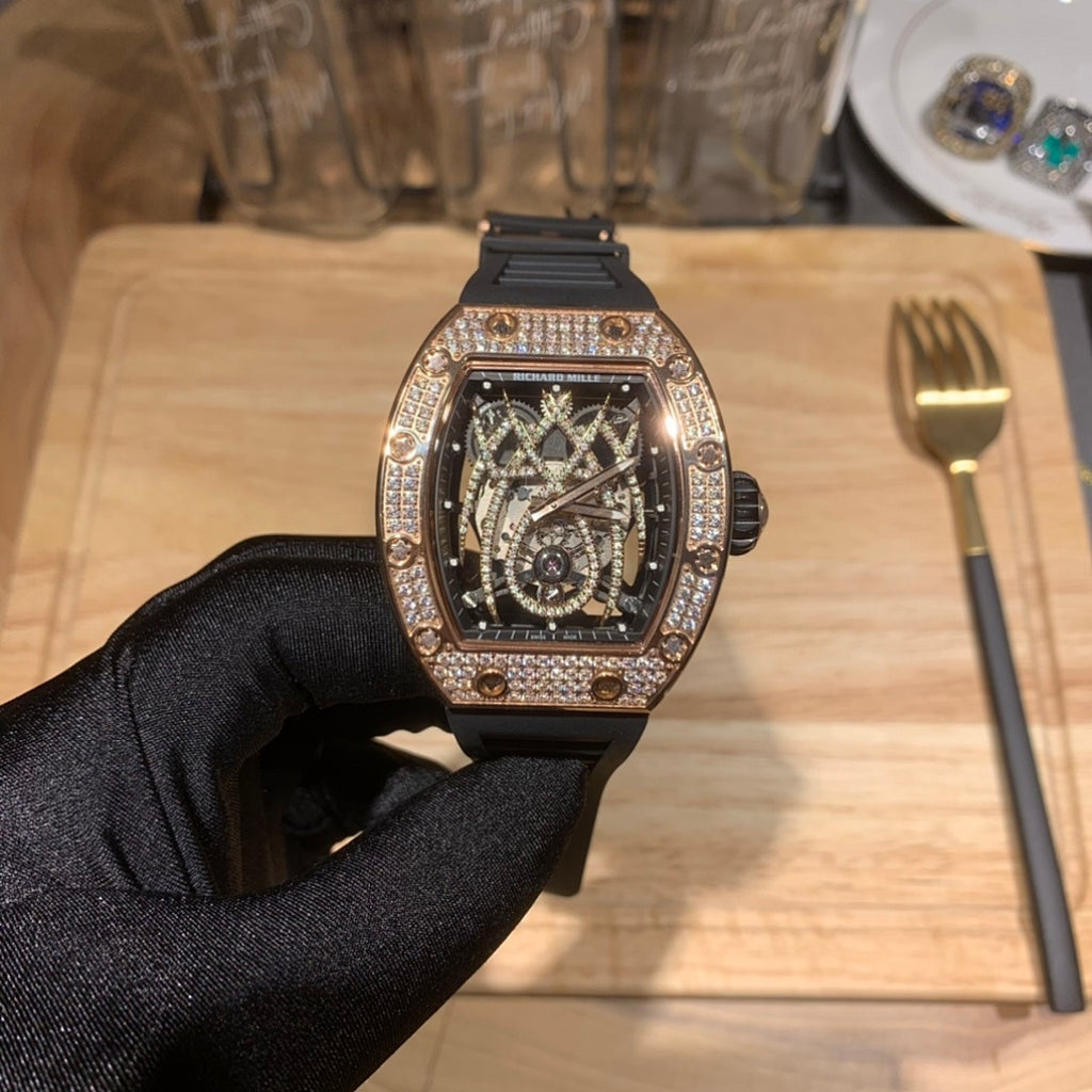 Richard Mille luxury wristwatch with rose gold diamond bezel and black strap