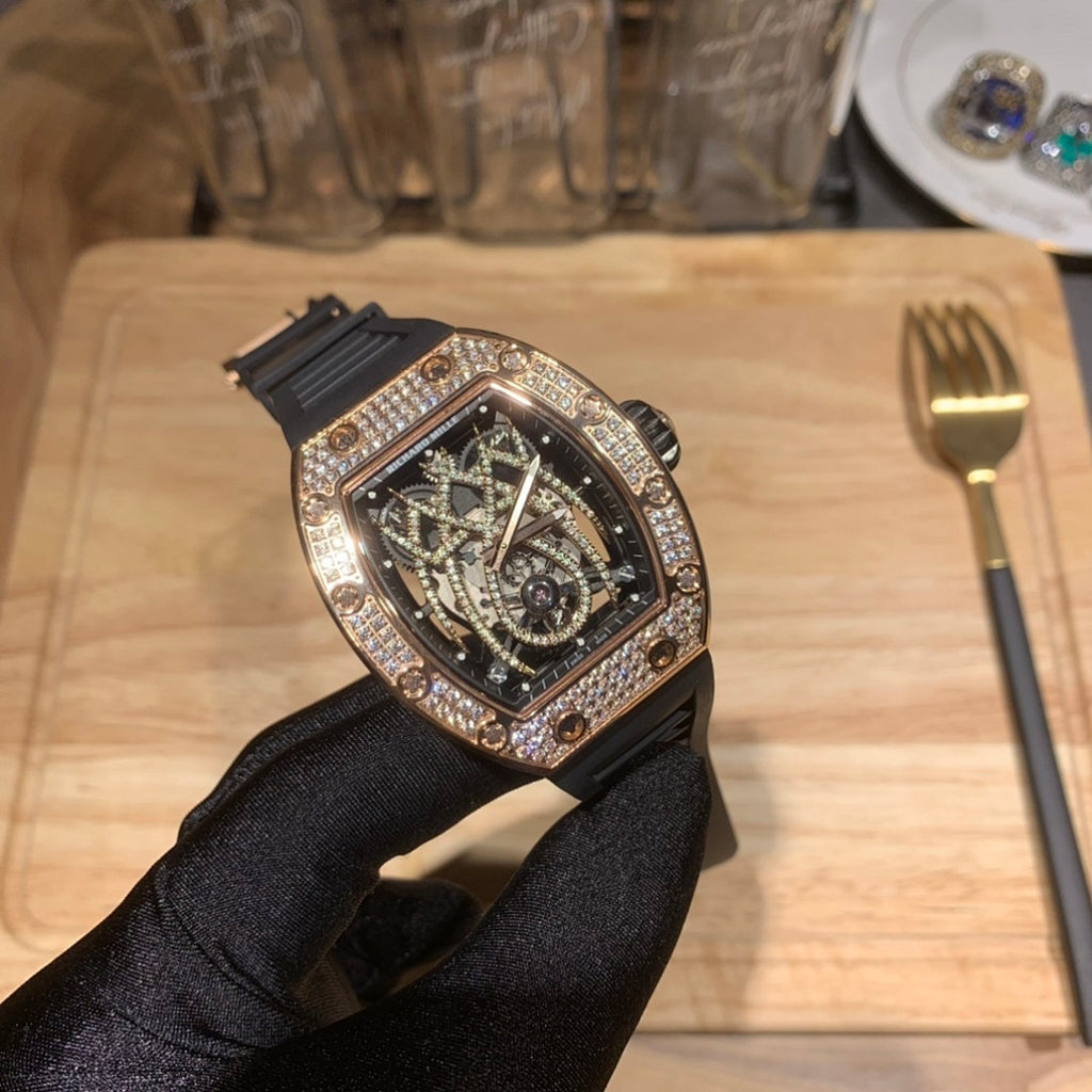 Richard Mille wristwatch with rose gold case, diamond bezel, and black rubber band