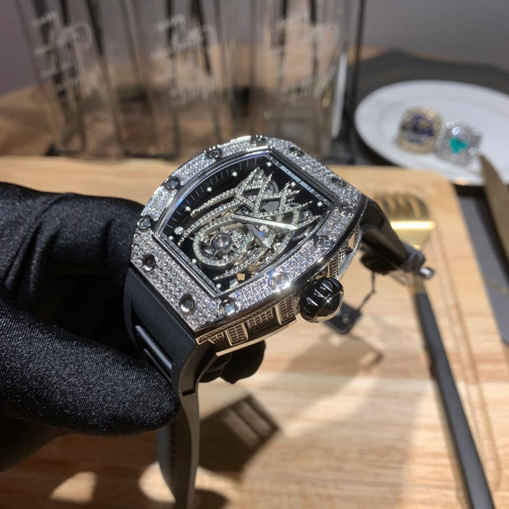 Richard Mille watch side view, black case and rubber strap, jeweled bezel, exposed movement