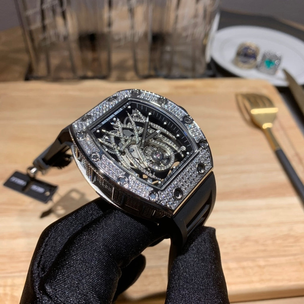 Richard Mille watch three-quarter view, black rubber strap, gem-set bezel, skeleton dial