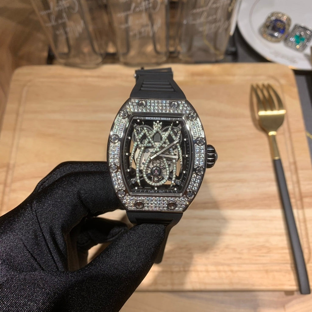 Richard Mille watch front view, sparkling bezel, black rubber strap, open-work skeleton dial