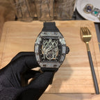 Richard Mille watch front view, sparkling bezel, black rubber strap, open-work skeleton dial