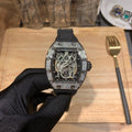 Richard Mille watch front view, jeweled bezel, black rubber strap, skeleton dial detail